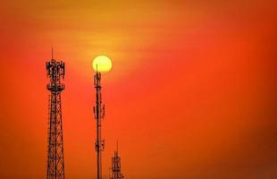 Silhouette telecommunications antenna for mobile phone at sunset photo