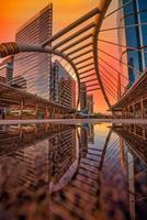 Modern structure bridge shape and building at sunset in train station, Bangkok, Thailand. photo