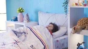 A boy sleeping sweetly in his bed. Boy sleeping soundly in his comfortable and peaceful bed. video