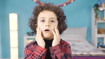 Boy is surprised looking at camera. Boy looking at camera giving expression of surprise and saying wow. video