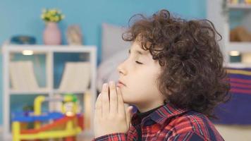 Boy hopes, prays. The boy hopes, prays, looking at the sky in the children's room. video