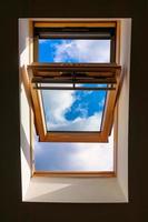 Looking up to the blue cloudy sky through modern square window photo