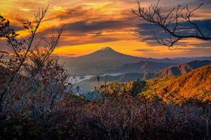 Mt. Fuji over Lake Kawaguchiko with autumn foliage at sunrise in Fujikawaguchiko, Japan. photo