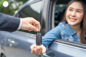 lease, rental car, sell, buy. Dealership manager send car keys to the new owner.  Sales, loan credit financial, rent vehicle, insurance,  renting, Seller, dealer, installment, car care business photo