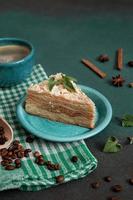 Layered Cake with cream Napoleon with mint on green background. Copy space photo