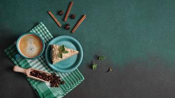 Top view of Layered Cake with cream Napoleon with mint on green background. Copy space photo