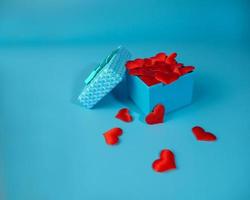 Blue box with red hearts on a blue background. Gift. photo