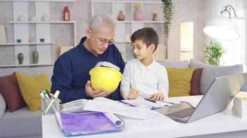 Happy father and son. Little son helping engineer father. The younger son is helping his engineer father. video