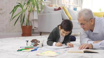 Father and son study together at home. Father helping his student son with homework. video