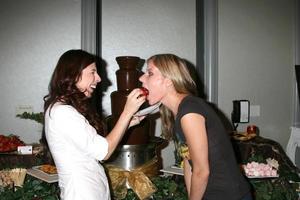 Heather Matarazzo feeding her Fiance Carolyn Murphy a chocolate covered strawberry at  the GBK Same Sex in The City  Wedding Show in Los Angeles CA onAugust 17 20082008 photo