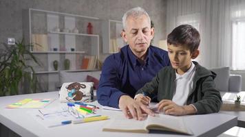 Father helping his son with his homework. A view of a father helping his son with his homework. video
