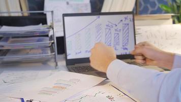 Man looking at financial earnings charts triumphs. Businessman looking at financial charts is profitable and rejoicing and approving. video