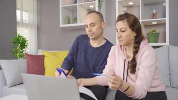Couples trying to pay off their debts by making financial calculations. The married couple are trying to pay off their high-priced debt by making financial calculations. video