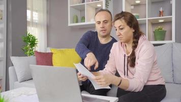 Stressed Couple Paying Their Bills Together. The married couple are trying to pay off their high-priced debt by making financial calculations. video