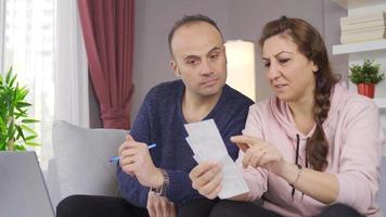 The married couple is satisfied with the household budget and incoming bills. The happy couple uses the household budget regularly and makes their payments on time. video