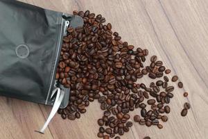 Detailed photo of coffee beans before being processed into a drink isolated on wood. Concept photo of the basic ingredients of coffee drinks.