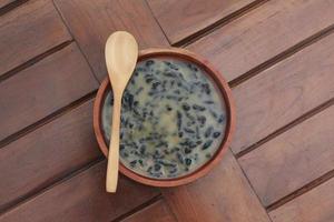 a close up of a bowl of traditional Indonesian drink called Dawet Ireng or black dawet. Indonesian traditional food photo concept.