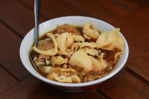 a close up of a ready-to-serve bowl of chicken porridge photo