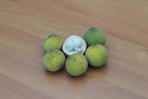 greenish yellow harp fruit isolated on money table has sweet and sour taste. Food concept photo. photo