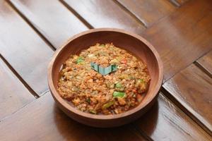 a close up Rujak Bebek or smashed fruit which is made from raw fruit crushed in a mortar and pestle and added with shrimp paste, chili and brown sugar. Indonesian traditional food photo concept.
