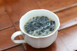 a close up of a glass of a traditional Indonesian drink called Dawet Ireng or black dawet. Indonesian traditional food photo concept.