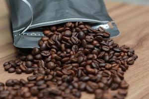 Detailed photo of coffee beans before being processed into a drink isolated on wood. Concept photo of the basic ingredients of coffee drinks.