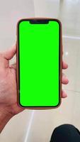La technologie de vert écran mobile téléphone, vert écran de main en portant mobile téléphone video