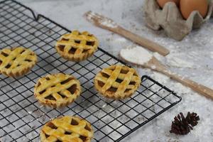 Small apple pie served on a cake rack, tastes sweet and savory. Food concept photo. photo