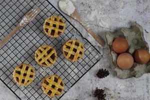 Small apple pie served on a cake rack, tastes sweet and savory. Food concept photo. photo