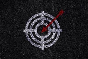 Target figure on dark wall, concept of achieving goal quality, Aim Target Red Symbols of goals and objectives over dark wall background. Business idea photo