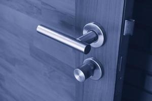 Stainless or Aluminum steel modern door handle on wooden door,Handle and keyhole detail Door lock,Interior door knob in bedroom photo