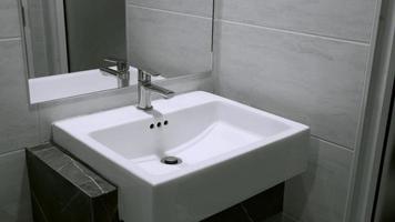 Interior of clean toilet white sink interior of toilet with of washing hands and mirror photo