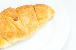 Croissant on white dish on white background photo