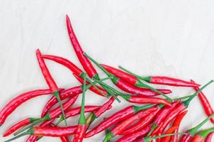 fresh red hot chilli peppers with spicy on the wooden photo