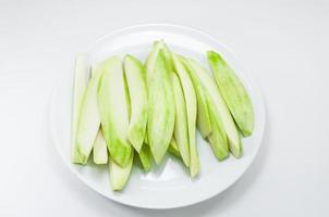 Mango split on white dish on white background photo