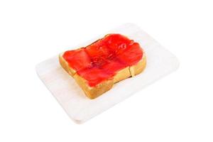 Strawberry butter toast on a wooden board isolated on white background.Toast bread photo