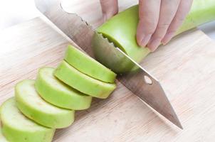 resh green eggplant sliced on wooden board photo