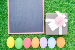 Close up Easter eggs on grass and blackboard mockup photo