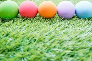 Colorful Easter eggs on green grass photo