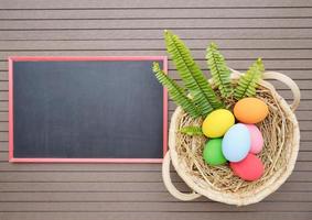 Easter eggs in the basket on and blackboard photo