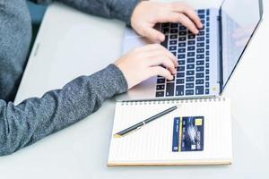 Woman using laptop payment credit card and for online shopping photo