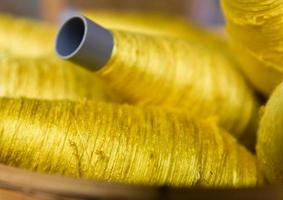 Sewing threads golden color photo