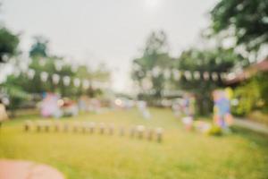 defocused bokeh and blur background of garden trees in sunlight with vintage toned. photo