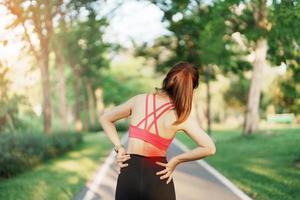 adult female with her muscle pain during running. runner woman having back and Waist body ache due to Piriformis Syndrome, Low Back Pain and Spinal Compression. Sports injuries and medical concept photo