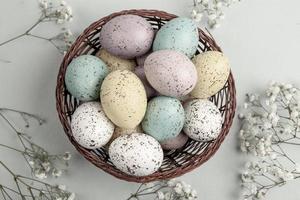 Pastel Easter eggs background. Spring greating card. Easter eggs in basket photo