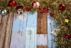Christmas background with garlands and toys on a wooden canvas background. Merry Christmas card. photo