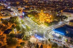 Aerial view from the drone of the illuminated centrum of Varna city at night photo