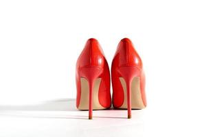 Bright red shoes on the white background. Back view picture. Beautiful high heels shoes. Element for design. Space for text. photo