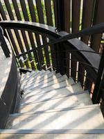 The concrete spiral staircase with the metal railing in the modern style. photo