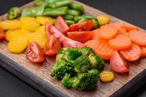 Salad of fresh and steamed vegetables cherry tomatoes, broccoli and carrots photo